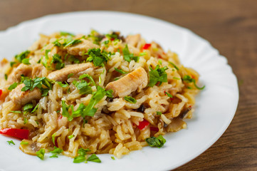 Chicken Breast with Rice, mushroom  and vegetables in white plate on wooden table background