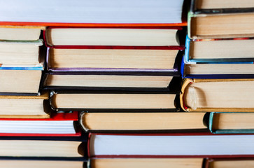 Fototapeta premium Stack of books background, many books piles with copy space for text