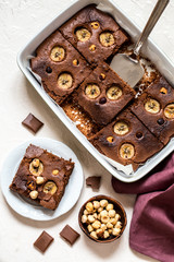 brownie with banana and hazelnut on white background in the form of pieces
