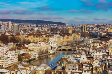 Fototapeta na wymiar The city of Zurich in Switzerland as seen from the tower of the Grossmunster cathedral in winter. Zurich is the largest city in Switzerland and the capital of the Swiss canton of Zurich.