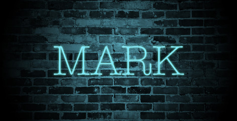 first name Mark in blue neon on brick wall