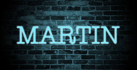 Obraz premium first name Martin in blue neon on brick wall