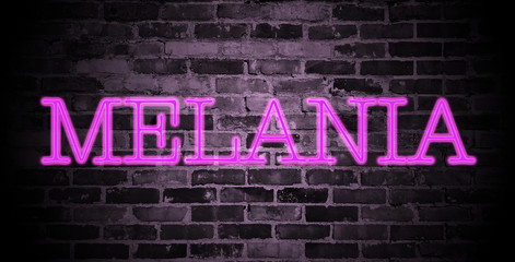 first name Melania in pink neon on brick wall