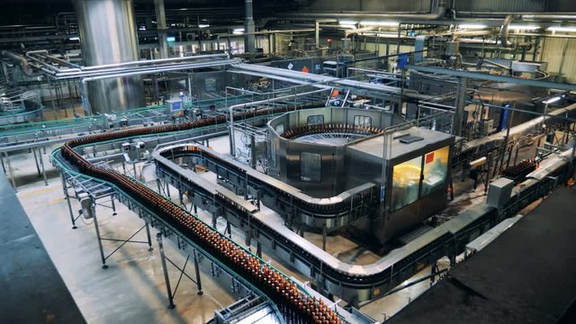 Brewery facility with equipment - conveyor, machines.