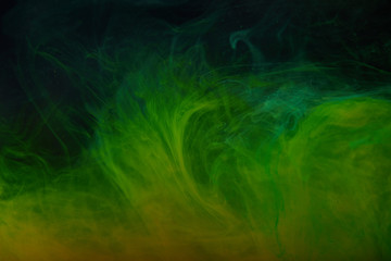 abstract background with green swirls of acrylic paint in water