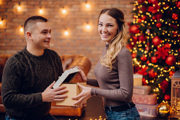 happy wife gets Christmas present from her husband