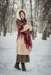 girl smiles in cold winter day outdoors in a snowy park