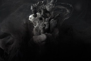 abstract splash of grey watercolor paint on black background