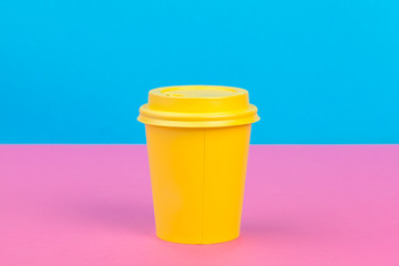 Takeaway cup of coffee on bright colored background