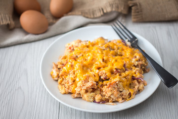 Scramble  Eggs with Cheese on Top in a White Plate 