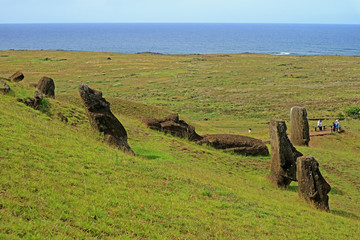 The slope full of abandoned giant Moai statues of Rano Raraku volcano with Pacific ocean in backdrop, Easter Island, Chile