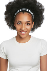 Three quarter portrait of a young smiling African girl with short curly hair. The woman is wearing a training headband and white T-shirt. The lady is posing and looking at camera on white background.