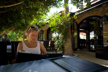 Mature woman sitting at the table of the Turkish cafe.