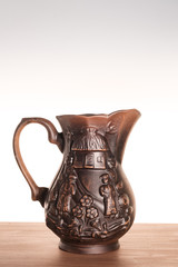 One clay jug on a light gradient background. Jug handmade Ukrainian national motif. Subject...