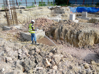 Construction workers spraying the anti termite chemical treatment to the soil at the construction...