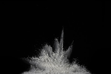 White powder explosion on black background. Colored cloud. Colorful dust explode. Paint Holi.