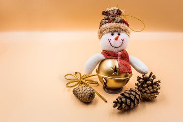 Christmas snowman toy and fir cones on a beige background
