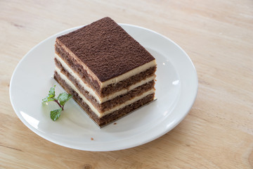Chocolate cake on wooden desk.Chocolate is a usually sweet, brown food preparation of roasted and ground cacao seeds