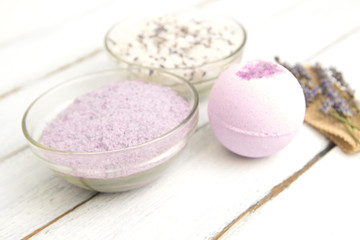 Natural herbal sea salt with aromatic lavender - perfect for relaxation. Cosmetic jars and bottles with salt, lavender flowers, bath bomb