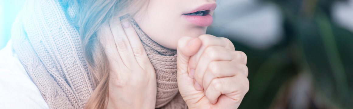 cropped image of sick woman coughing at home