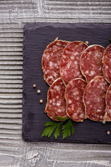 Saucisson sec delicious french salami on a wooden background