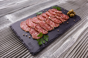 Saucisson sec delicious french salami on a wooden background