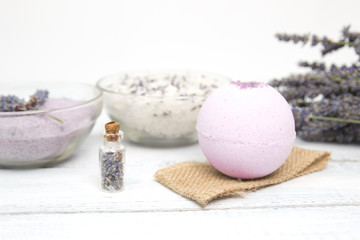 Fototapeta na wymiar Natural cosmetics. Handmade lavender bath bombs and lavender flowers on white wooden planks