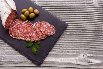Saucisson sec delicious french salami on a wooden background