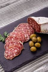 Saucisson sec delicious french salami on a wooden background