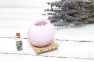 Natural cosmetics. Handmade lavender bath bombs and lavender flowers on white wooden planks