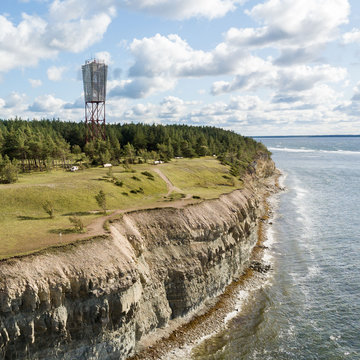 Panga coastal cliff and lighthouse (Panga pank), Saaremaa island, near Kuressaare, Estonia. North-Estonian limestone escarpment, Baltic Klint.