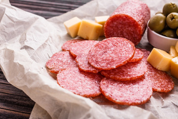 delicious sliced salami on a wooden background