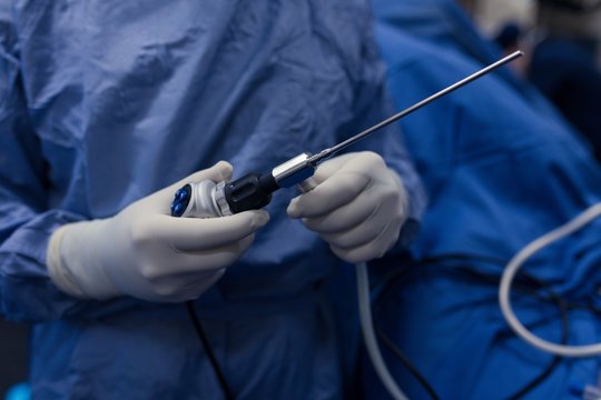 Female Surgeon Holding Medical Instrument In Hospital