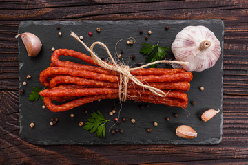 kabanos delicious polish snack sausage on a stone plate wooden background