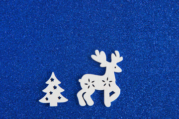 Reindeer and tree on blue christmas background