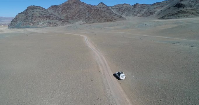4k 60 fps Mongolia Aerial view of Altai desrt track with 4x4 driving - starting on track