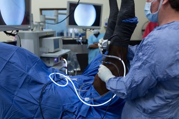 Female surgeon examining a horse in operation theatre