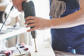 Strong young worker working in the woodworking industry.