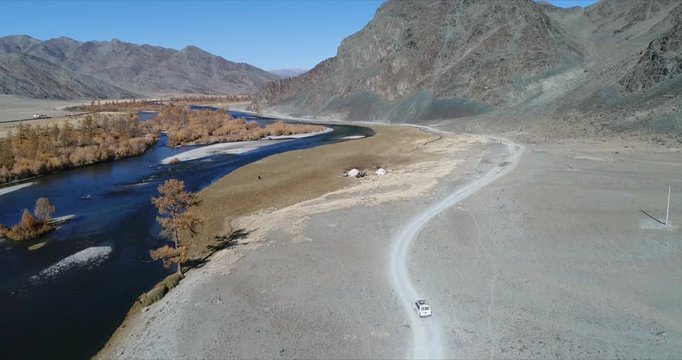 4k 60 fps Mongolia Aerial view of Altai desrt track with 4x4 driving -  panorama with ger tents