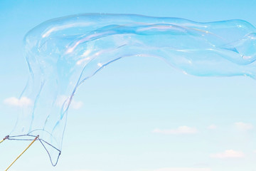 Huge soap bubble on a sky background and street lamp.
