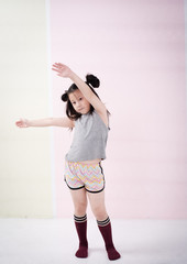 The little girl is stretching body before exercise