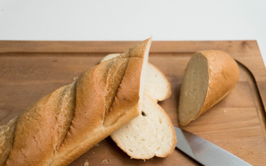 baguette on wooden board with knife