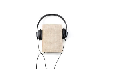 audiobook with black headphones, from above with space for text