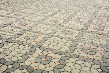 Fototapeta premium patterned paving tiles, old cement brick floor background
