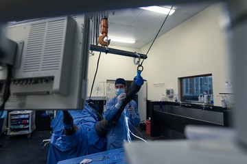 Female surgeon examining a horse in operation theatre
