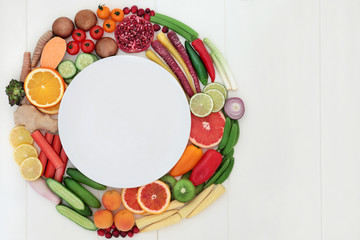 Health food for fitness concept with fresh fruit, vegetables and spices with super foods very high in antioxidants, protein, anthocyanins, vitamins and dietary fibre. Top view on white wood.