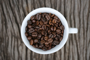 Coffee beans in a white coffee cup