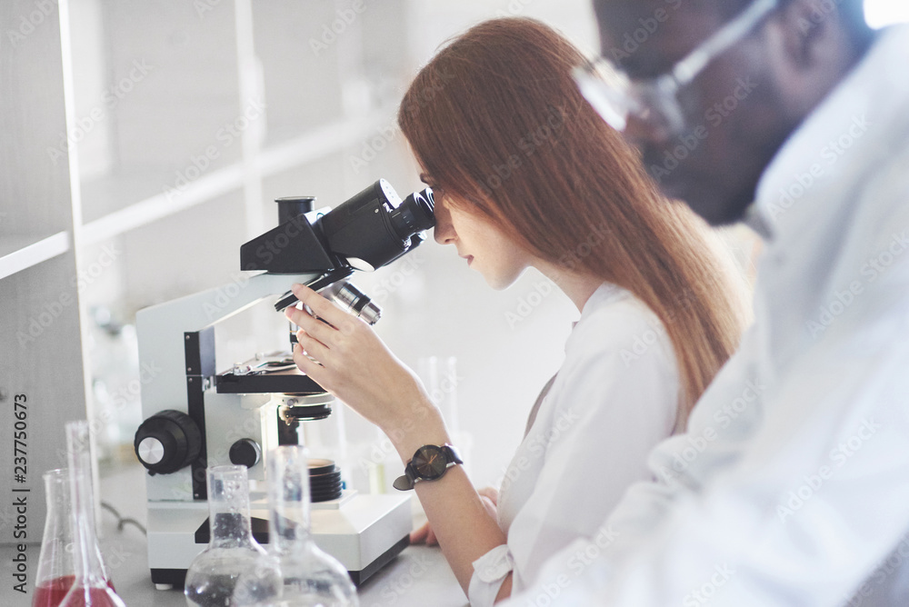 Poster lab assistant with microscope laboratory glassware bulb with chemicals.