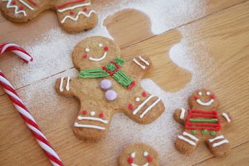 Christmas background with gingerbread men cookies on wooden table with selective focus