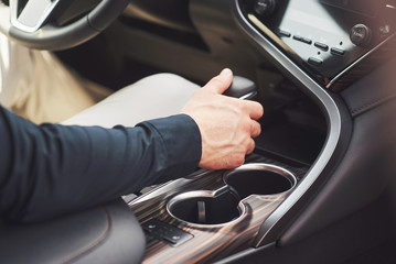 young man is a man behind the wheel of an arboreal car